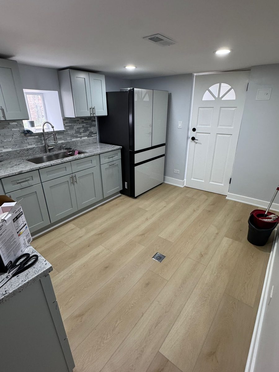 Kitchen floor installed by FloorCraft in a pale oak plank